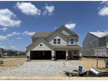 New construction home with stone accents and a two-car garage is bathed in sunlight at 4390 Red Pine Dr, Bargersville, IN 46106