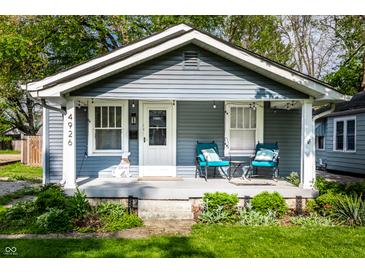 Charming home with a welcoming front porch, manicured lawn, and inviting curb appeal at 4926 Crittenden Ave, Indianapolis, IN 46205