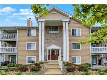 Charming condo with classic architectural design and beautiful landscaping with colorful flowerbeds at 6518 Jade Stream Ct # 312, Indianapolis, IN 46237
