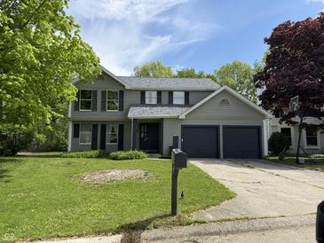 Charming two-story home featuring a two-car garage and a well-maintained front lawn at 8075 Cardinal E Cv, Indianapolis, IN 46256
