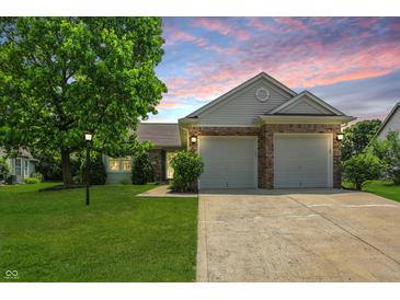 Charming home featuring brick accents, a two-car garage, and a well-manicured lawn at 863 Lionshead Ln, Greenwood, IN 46143