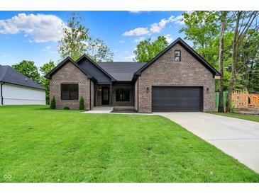 Charming brick home with a well-manicured lawn and a two-car garage, providing comfort and curb appeal at 9811 Warren Pl, Indianapolis, IN 46229