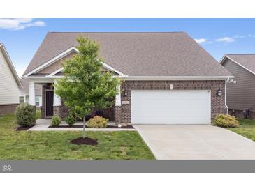 Front exterior of brick home featuring a two-car garage and well-maintained front lawn at 13321 N White Cloud Ct, Camby, IN 46113