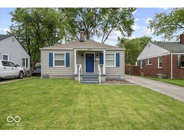 Charming single-story home with blue shutters and a well-manicured front lawn at 1907 N Drexel Ave, Indianapolis, IN 46218