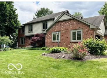 Charming two-story home featuring a manicured front lawn and inviting curb appeal at 1941 Spruce Dr, Carmel, IN 46033