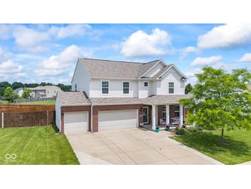 Charming two-story home boasts a brick facade, attached two-car garage, and manicured lawn at 2337 Hanover Rd, Brownsburg, IN 46112