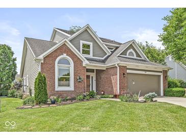 Charming brick home with well-manicured lawn and attached two-car garage at 3535 Clearwater Cir, Indianapolis, IN 46240