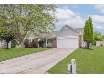 Charming single-story home with a well-manicured lawn and attached two-car garage at 374 Pomona Ct, Greenfield, IN 46140