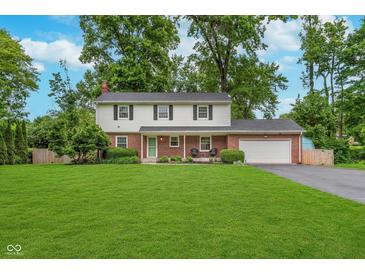 Charming two-story home with a well-manicured lawn and beautiful landscaping at 4840 E 77Th St, Indianapolis, IN 46250