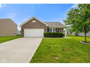 Charming brick home featuring an attached two-car garage and a well-maintained lawn with landscaping at 6415 Calabash Pl, Indianapolis, IN 46217