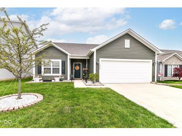 Charming single-Gathering home with green lawn, concrete driveway, and inviting front entrance at 6556 Sulgrove Pl, Indianapolis, IN 46221