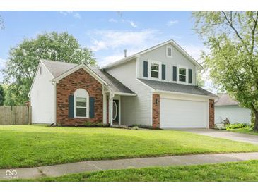 Charming two-story home with brick accents and a well-manicured lawn at 7541 Southern Lakes Dr, Indianapolis, IN 46237