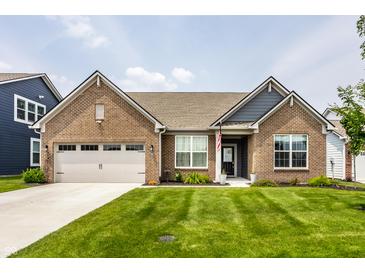 Beautiful brick home featuring a well-manicured lawn, attached garage and inviting curb appeal at 9718 Haughton Ln, McCordsville, IN 46055