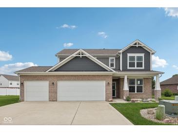 Charming two-story home with brick and siding exterior and a three-car garage at 13163 N Departure W Blvd, Camby, IN 46113
