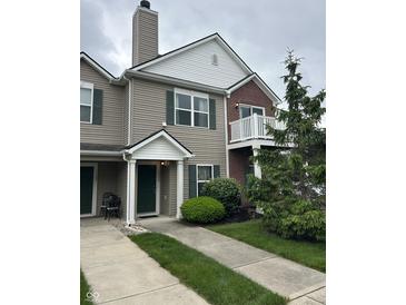 Charming townhouse featuring a mix of vinyl siding and brick accents, with a private balcony and well-manicured landscaping at 13225 Deception Pass # 1200, Fishers, IN 46038