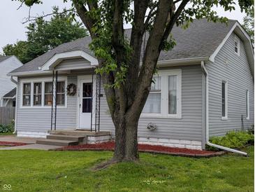 Charming home featuring gray siding, well-manicured lawn, and an inviting entrance with a decorative wreath at 1728 Newton St, Columbus, IN 47201