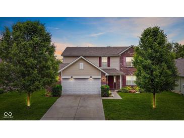 Charming two-story home with a brick and siding facade, attached garage, and beautifully landscaped front yard at 2509 Cedarmill Dr, Franklin, IN 46131