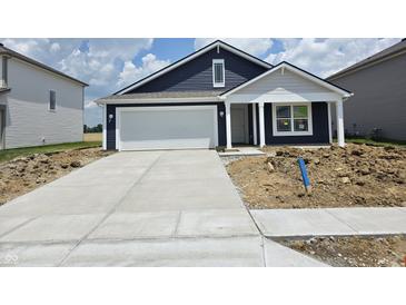 Charming single-story home with blue siding, a white garage door, and a well-manicured lawn at 3266 W Longbranch Dr, Monrovia, IN 46157
