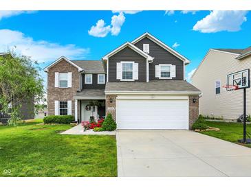 Charming two-story home with a well-manicured lawn, inviting curb appeal, and a two-car garage at 3284 Clary Blvd South Dr, Greenwood, IN 46143
