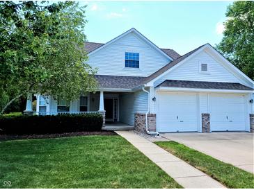 Charming two-story home with a well-manicured lawn, attached two-car garage, and inviting front porch at 3862 Cornwallis Ln, Carmel, IN 46032