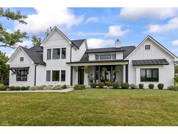 Stunning two-story white home with black trim and a meticulously landscaped front yard at 4808 Lakeview Dr, Greenwood, IN 46143