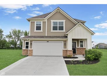 Charming two-story home boasts a manicured lawn, attached two-car garage, and a welcoming facade at 6917 Wolf Creek Ct, Whitestown, IN 46075