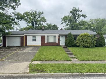 Charming single-story home featuring a well-maintained lawn and an attached one car garage with a concrete driveway at 7929 Roy Rd, Indianapolis, IN 46219