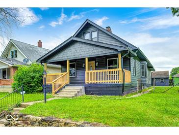 Charming home with a covered front porch and well-maintained lawn at 805 N Euclid Ave, Indianapolis, IN 46201