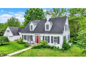 Charming white two-story home with a red front door and well-manicured lawn at 8301 E County Road 801 S, Plainfield, IN 46168