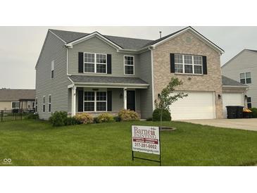 Charming two-story home with a combination of vinyl siding and brick facade, complemented by well-maintained landscaping at 1287 Highland Lake Way, Brownsburg, IN 46112