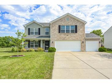 Charming two-story home featuring brick and siding, with a well-manicured lawn and two-car garage at 1287 Highland Lake Way, Brownsburg, IN 46112