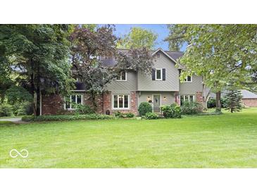 Charming two-story home boasts a well-manicured lawn, brick accents, and neutral siding for a welcoming curb appeal at 13297 Highland Springs Dr, McCordsville, IN 46055