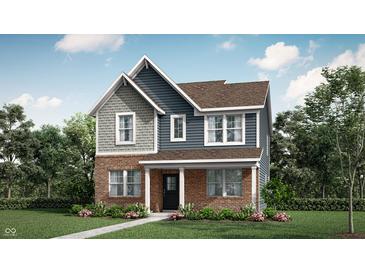 Charming two-story home with brick and blue siding and a well-manicured lawn at 15395 Alperton Rd, Fishers, IN 46037