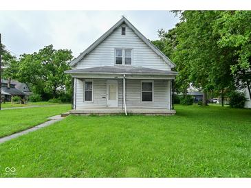 Charming home featuring a covered front porch and a well-maintained grassy lawn at 2622 Ethel Ave, Indianapolis, IN 46208