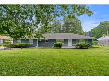 Charming single-story home featuring blue brick exterior and well-manicured lawn at 3735 Marrison Pl, Indianapolis, IN 46205