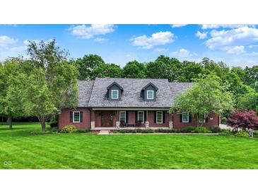 Charming brick home featuring a well-manicured lawn and inviting front porch at 4123 S Village Row, New Palestine, IN 46163