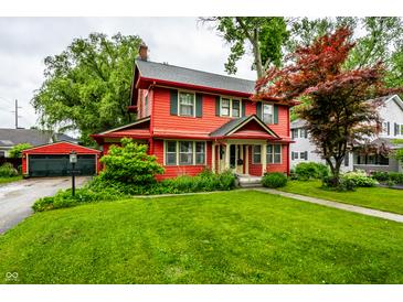 Beautiful two-story home with a detached garage and green lawn at 4912 Central Ave, Indianapolis, IN 46205