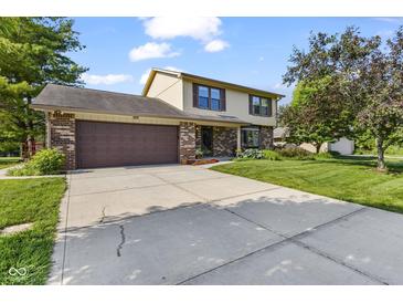 Charming two-story home featuring a brick and vinyl exterior, lush landscaping, and an attached two-car garage at 5325 Ridge Hill Way, Avon, IN 46123