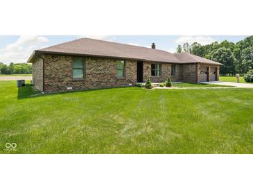 Charming brick home featuring a lush lawn and well-maintained landscaping at 5905 N County Rd 600 E, Brownsburg, IN 46112
