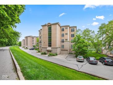 An attractive residential building with a manicured lawn is nestled in lush greenery at 6760 Spirit Lake Dr # 201, Indianapolis, IN 46220