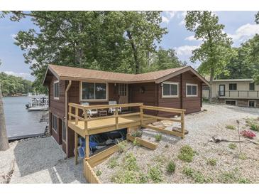 Charming lakeside cabin with a wooden deck and access to the water for peaceful waterfront living at 6937 Muskrat Dr, , IN 46164