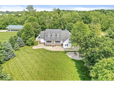 Aerial view showcases the home with manicured lawn, mature trees, and inviting outdoor space at 7221 State Road 42, Martinsville, IN 46151