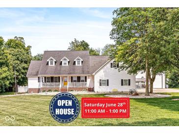 Charming home featuring a welcoming front porch, well-manicured lawn, and a classic design with dormer windows at 7221 State Road 42, Martinsville, IN 46151