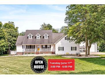 Charming two-story home with a welcoming front porch and well-manicured lawn at 7221 State Road 42, Martinsville, IN 46151