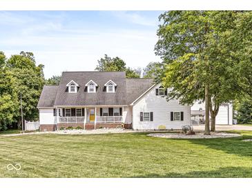 Charming two-story home with a welcoming front porch and a lush, well-manicured lawn at 7221 State Road 42, Martinsville, IN 46151