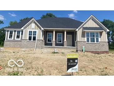 Charming one-story home featuring stone accents, a covered porch, and stylish architectural details at 9437 Dogwood Dr, McCordsville, IN 46055