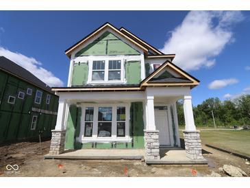 New home in progress with white trim, stone accents, and a covered front porch, showcasing modern design and curb appeal at 1813 Real St, Indianapolis, IN 46240