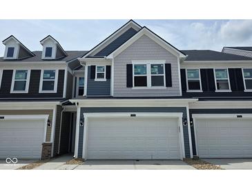 Charming two-story townhouse featuring gray siding, black shutters, and a spacious two-car garage at 18736 Moray St, Westfield, IN 46074