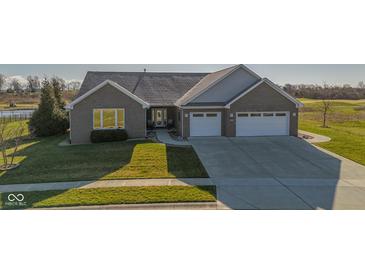 Beautifully landscaped brick home with a two-car garage and view of the golf course at 201 St Andrews Ave, Edinburgh, IN 46124