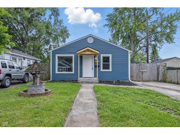 Charming blue home featuring a well-manicured lawn and inviting walkway at 2315 Spann Ave, Indianapolis, IN 46203